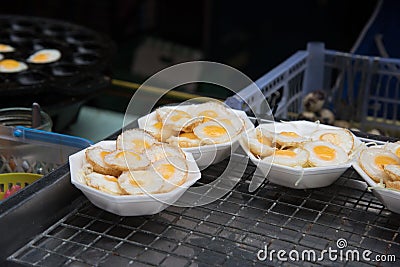 Small fried quail eggs on the asian market Stock Photo