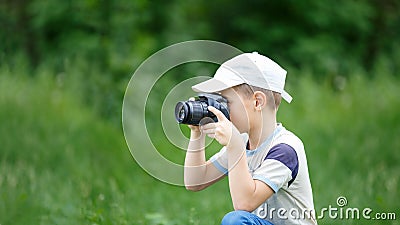 Small funny boy practicing in taking photography Stock Photo