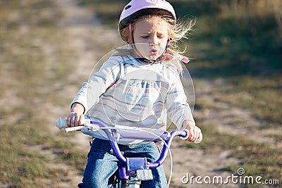 Small funny kid riding bike Stock Photo