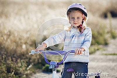 Small funny kid riding bike Stock Photo