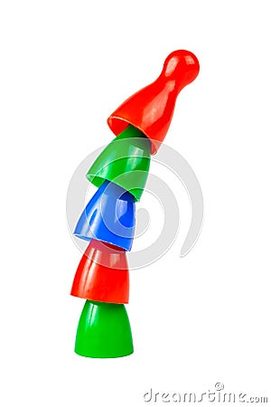 Small game pieces placed standing on top of each other Simple colorful pieces bent curved tower symbol Teamwork, team effort Stock Photo