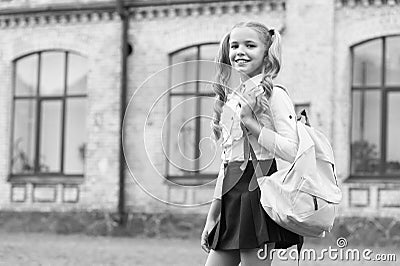 small girl carry backpack. happy to be here. happy childhood memories. on the way to lesson. back to school. kid study Stock Photo
