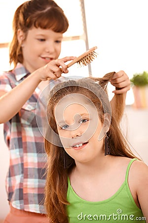 Small girl getting hair comb Stock Photo