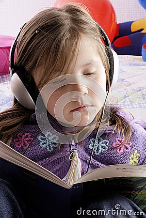 Small girl with headphones Stock Photo