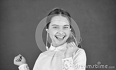 small girl in headphones at blackboard. listening audio book. free ebook. cool girl in headset listening to music. e Stock Photo