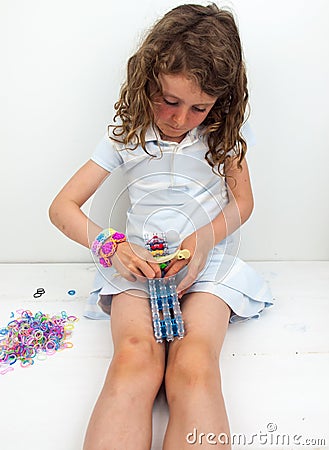 Small girl loom banding Stock Photo