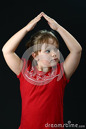 Small girl making roof from hands above her Stock Photo