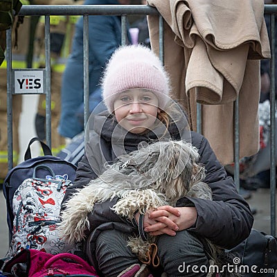 Small girl and pet dog at the Mlyny refugee centre near the Ukraine border with Poland Editorial Stock Photo