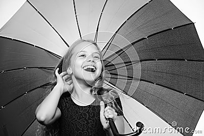 Small girl with umbrella in rainy weather. Happy little girl with umbrella. Autumn fashion. Child. Happy childhood Stock Photo