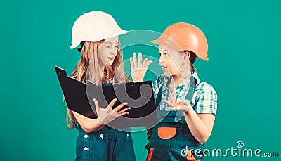 Small girls repairing together in workshop. Labor day. 1 may. school project. Happy children. Little kids in helmet Stock Photo