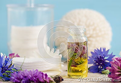 Small glass bottle of aroma cosmetic oil with flowers extracts. Stock Photo