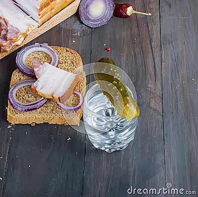 Small glass with Russian vodka,sandwich with Smoked bacon and Stock Photo