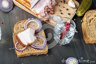 Small glass with Russian vodka,sandwich with Smoked bacon and Stock Photo