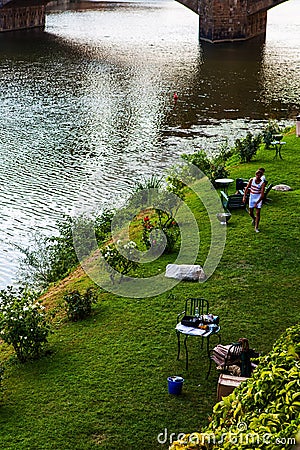 Small green area for relaxation near Ponte Vecchio in Florence Editorial Stock Photo
