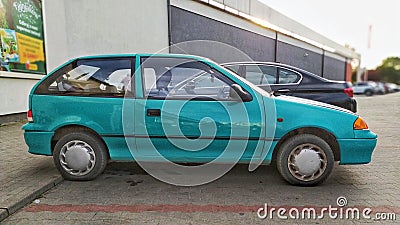 Old green compact car Suzuki Swift GLS parked Editorial Stock Photo