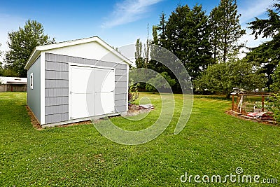 Small grey shed with white trim. Countryside real estate Stock Photo