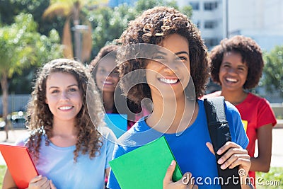 Small group of laughing african caucasian and latin female students Stock Photo