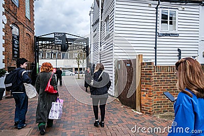 Small Group Of People Carrying Shopping Bags Walking Editorial Stock Photo