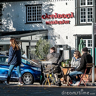 Small Group Of People Sitting Outside Talking And Drinking Coffee Editorial Stock Photo