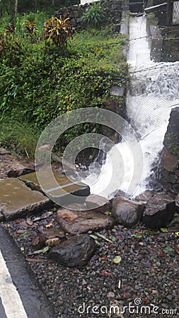  A small gush of water comes through a drain. Stock Photo