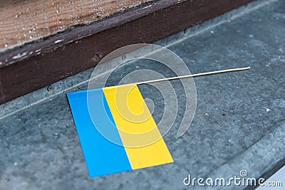 Small hand Ukrainian flag placed on the windowsill Stock Photo
