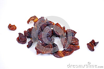 The small handful of dried blue plum lies on a table on a white background. Stock Photo