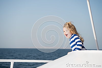 Small happy baby boy captain of yacht in marine shirt Stock Photo