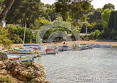 Small harbor with beach with privately owned small colorful boats in Antibes, French Riviera Editorial Stock Photo