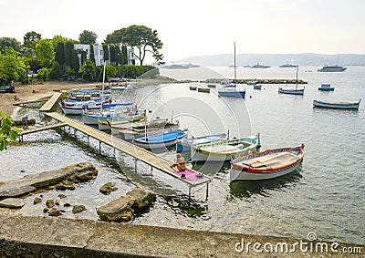 Small harbor with beach with privately owned small colorful boats in Antibes, French Riviera Editorial Stock Photo