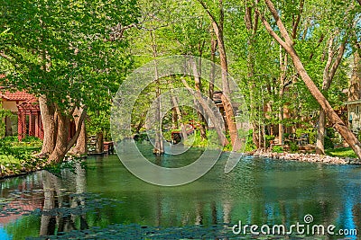 A small hideaway lake in Ransom Canyon in Texas is lined with homes Stock Photo