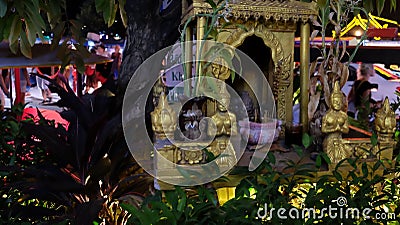 Small Hindu sanctuary on the street of an Asian city, night time Editorial Stock Photo