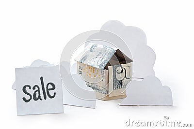 Small house made of dollar banknote isolated on white background. Inscription sale. Concept of real estate sale. Origami of Stock Photo