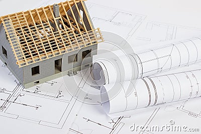 Small house under construction and electrical drawings, concept of building home Stock Photo