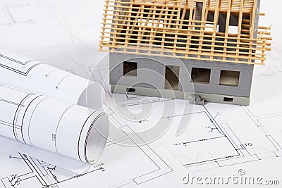 Small house under construction and electrical drawings, concept of building home Stock Photo