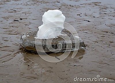 A small ice floe with a bizarre snow figure. Stock Photo