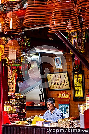 Small incense shop for prayers inside a Chinese temple, South of Vietnam Editorial Stock Photo