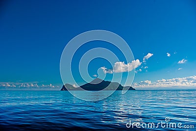 Small island in blue sea Stock Photo