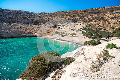 The small isolated gulf of Vathi, in Crete, with sandy beach and some lucky campers. Stock Photo