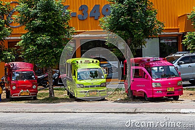 small Japanese trucks converted into taxis for tourists called tuk tuk in Thailand on the island of Phuket. Multi-colored cars on Editorial Stock Photo