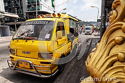 small Japanese trucks converted into taxis for tourists called tuk tuk in Thailand on the island of Phuket. Multi-colored cars on Editorial Stock Photo