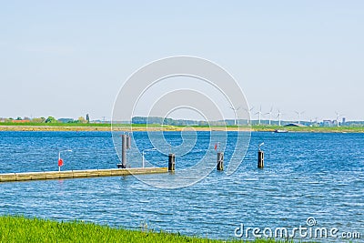 Small jetty in tholen city with boats sailing on the water, Scenery of the Oosterschelde, Bergse diepsluis, Zeeland, The Stock Photo