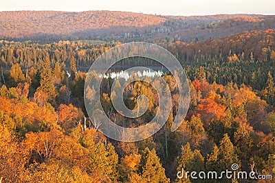 Small lake among hills and trees with fall color in northern Minnesota Stock Photo