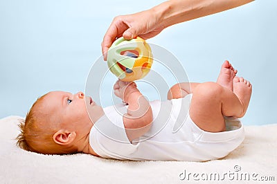 Small laying baby with toy Stock Photo