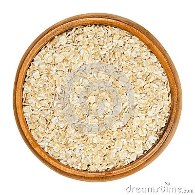 Oatmeal, rolled white oats in wooden bowl Stock Photo