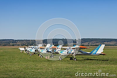 Small and light airplanes stand on a lawn. Stock Photo