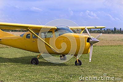 Small and Light Yellow Piper Aircraft near to the Runaway Ready to Take Off Stock Photo