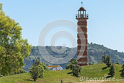 Small lighthouse on lawn with trees in Belen Editorial Stock Photo