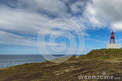 Small lighthouse near the port of Ponta Delgada Stock Photo