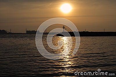 Small lighthouse at sunset Stock Photo