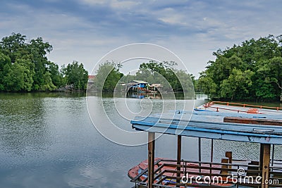 Small local ferry boat docking along the river, Stock Photo